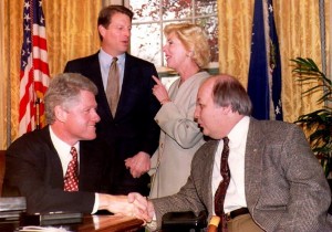 WASHINGTON, DC - NOVEMBER 24: U.S. President Bill Clinton (L) congratulates former Reagan Administration Press Secretary James Brady (R) on the passage of the Brady bill as Vice President Al Gore (2nd-L) and Sarah Brady look on during a meeting at the White House 24 November 1993. The bill will require a five-day waiting period and background check on handgun buyers. (JENNIFER YOUNG/AFP/Getty Images)